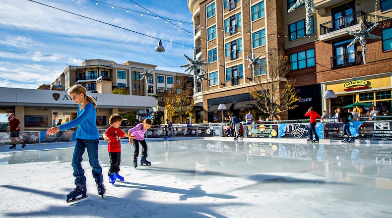 December 26, 2015 Alpharetta - Ashlyn Johnson (left) skates past Wyatt Andrews and his sister Georgia at the ice rink at Avalon in Alpharetta on Saturday, December 26, 2015. Unseasonably warm weather has caused some rinks around the metro area to close but Avalon is one that has stayed the course. JONATHAN PHILLIPS / SPECIAL
