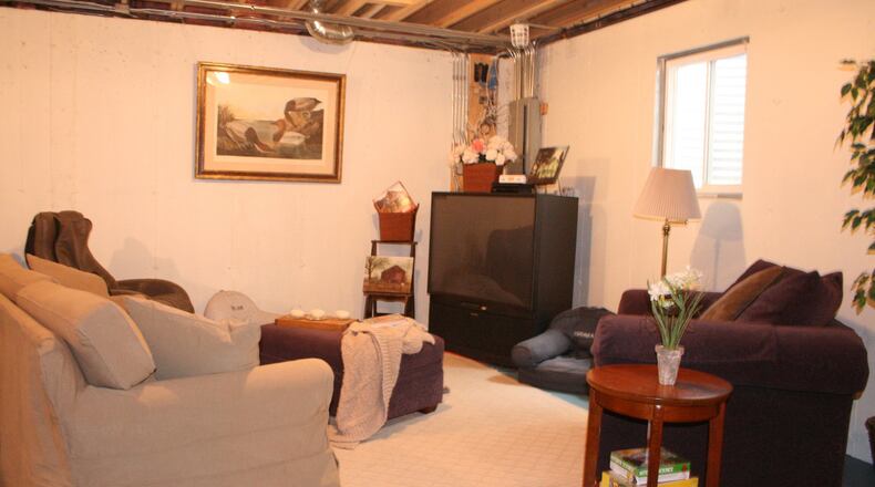 An unfinished basement is made to feel comfy and cozy by creating a lounge area. (Design Recipes)