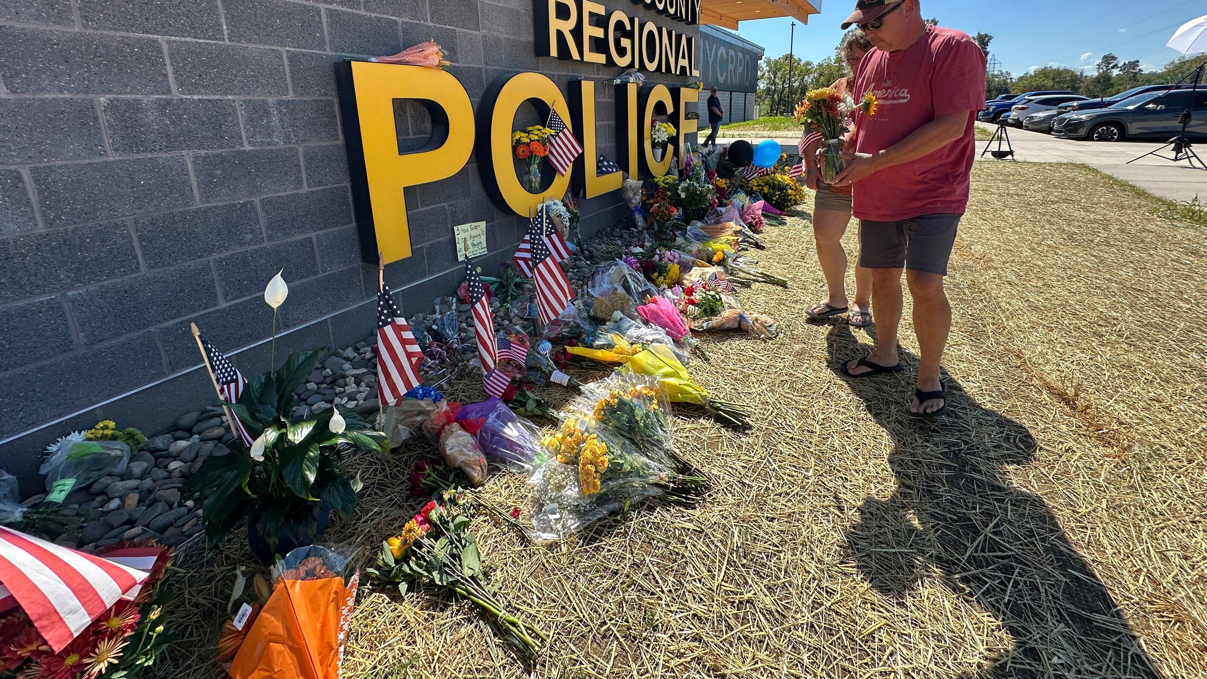 A memorial for police officers killed in a shooting is shown outside the Northern York County Regional Police Department, Thursday, Sept. 18, 2025 in York, Pa. (AP Photo/Tassanee Vejpongsa)