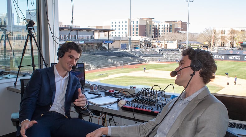 Twin brothers Chris Caray (left) and Stefan Caray (right) are in the broadcast booth at Hodgetown stadium in Amarillo, Texas. They are the new radio announcers for the Amarillo Sod Poodles minor-league baseball team. (Photo by Isaac Galan / Special to the AJC)