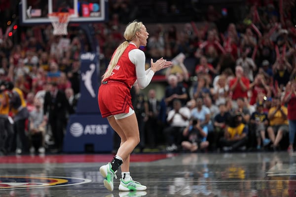 Indiana Fever's Sophie Cunningham cheers during the second half of a WNBA basketball game against the Atlanta Dream, Friday, July 11, 2025, in Indianapolis. (AP Photo/AJ Mast)