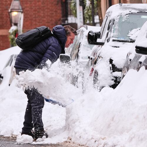 A man digs out his car on Beacon Hill following a winter storm that dump more than a foot of snow across the region, Monday, Jan. 26, 2026, in Boston. (AP Photo/Charles Krupa)