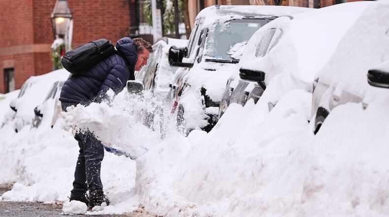 A man digs out his car on Beacon Hill following a winter storm that dump more than a foot of snow across the region, Monday, Jan. 26, 2026, in Boston. (AP Photo/Charles Krupa)
