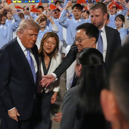 President Donald Trump talks during an arrival ceremony Wednesday, May 13, 2026, at Beijing Capital International Airport in Beijing, with Eric Trump, right. (AP Photo/Mark Schiefelbein)