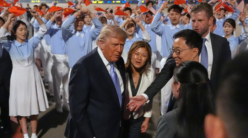 President Donald Trump talks during an arrival ceremony Wednesday, May 13, 2026, at Beijing Capital International Airport in Beijing, with Eric Trump, right. (AP Photo/Mark Schiefelbein)