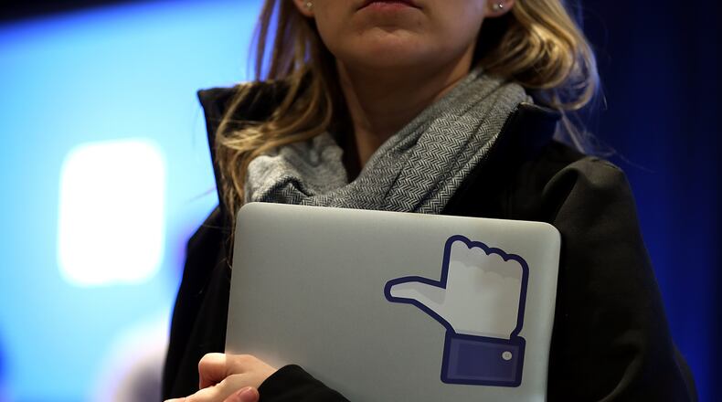 MENLO PARK, CA - APRIL 04: A Facebook employee holds a laptop with a 'like' sticker on it during an event at Facebook headquarters during an event at Facebook headquarters on April 4, 2013 in Menlo Park, California. (Photo by Justin Sullivan/Getty Images)