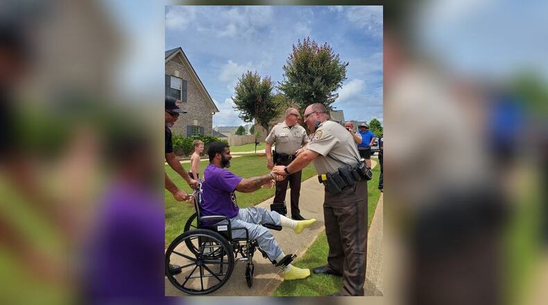 Henry County deputies greet Officer Max Brewer in his neighborhood Monday afternoon. Brewer spent more than a month in the hospital after being struck by an ATV during the second night of protests downtown.
