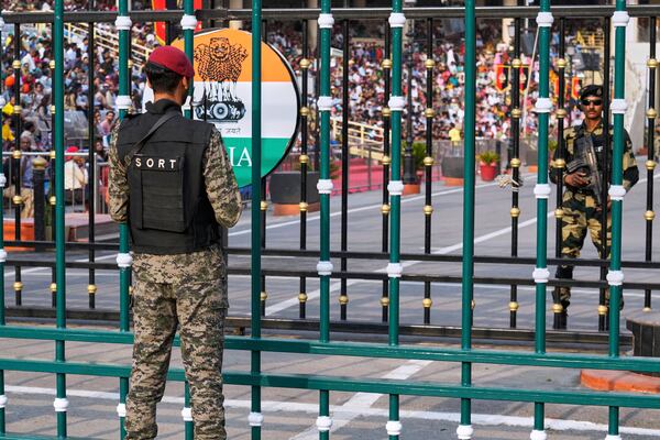 Pakistan's paramilitary soldier, left, and Indian Border Security Forces soldier, right, stand guard on their sides, during a daily closing ceremony at the Wagah, a joint post on the Pakistan and India border, near Lahore, Pakistan, Saturday, May 3, 2025. (AP Photo/K.M. Chaudary)