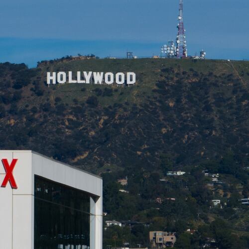 FILE - A Netflix sign is displayed atop a building in Los Angeles, on Dec. 18, 2025, with the Hollywood sign in the distance. (AP Photo/Jae C. Hong, File)