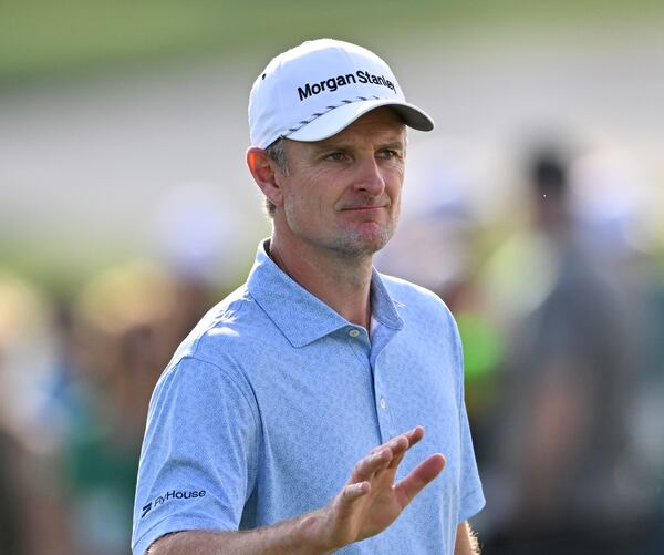 Justin Rose waves to patrons on 18th green during first round of the Masters golf tournament, at Augusta National Golf Club, Thursday, April 10, 2025, in Augusta, Ga. (Hyosub Shin / AJC)