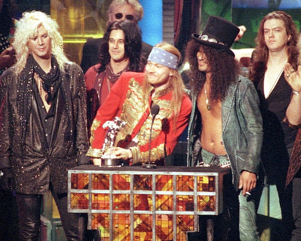 FILE - Guns N' Roses, from left, Michael "Duff" McKagan, Dizzy Reed, Axl Rose, Saul "Slash" Hudson and Matt Sorum, accept the Michael Jackson Video Vanguard Award at the MTV Video Music Awards in Los Angeles on Sept. 9, 1992. (AP Photo/Kevork Djansezian, File)