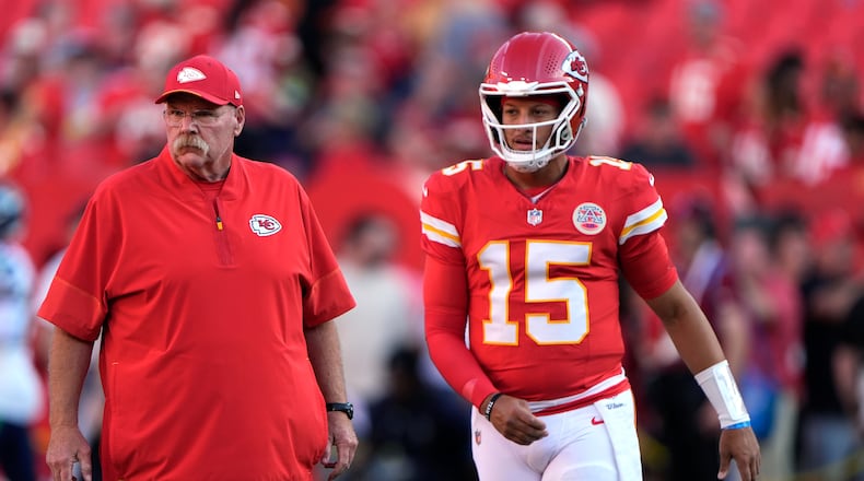 Kansas City Chiefs head coach Andy Reid, left, and Chiefs quarterback Patrick Mahomes (15) watch players warm up prior to a preseason NFL football game against the Seattle Seahawks, Friday, Aug. 28, 2026, in Kansas City, Mo. (AP Photo/Charlie Riedel)