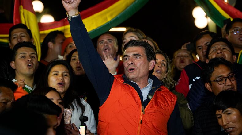 Presidential candidate Rodrigo Paz, center, addresses supporters after early results showed him leading in the presidential election in La Paz, Bolivia, Sunday, Aug. 17, 2025. (AP Photo/Freddy Barragan)