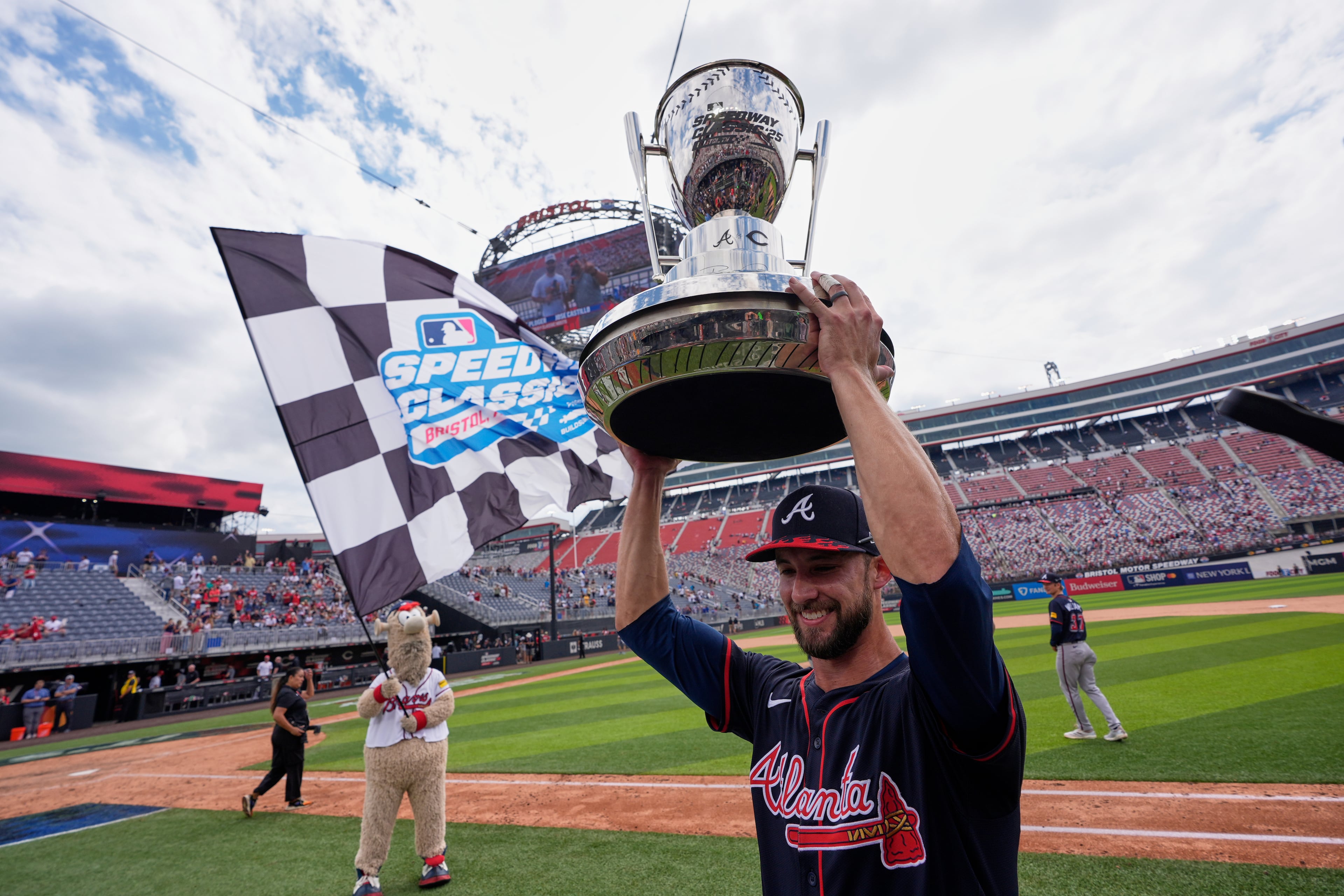 Atlanta Braves outfielder Eli White holds the trophy after their win against the Cincinnati Reds in the MLB Speedway Classic baseball game at Bristol Motor Speedway in Bristol, Tenn., Sunday, Aug. 3, 2025. Play was resumed today after yesterday's weather delay. (AP Photo/George Walker IV)