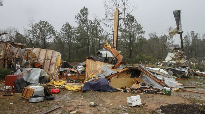 Parts of mobile homes and other property lay strewn throughout a neighborhood Sunday, Jan. 22, 2017, on Green Loop Road in Lauderdale, Miss., after a tornado passed through the area late Saturday. (Paula Merritt/The Meridian Star via AP)