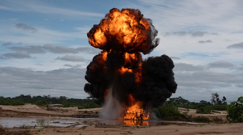 The Peruvian Navy destroys a dredge used for illegal mining near the Malinowski River in the Tambopata National Reserve in Puerto Maldonado, Peru, Tuesday, Aug. 11, 2026. (AP Photo/Guadalupe Pardo)