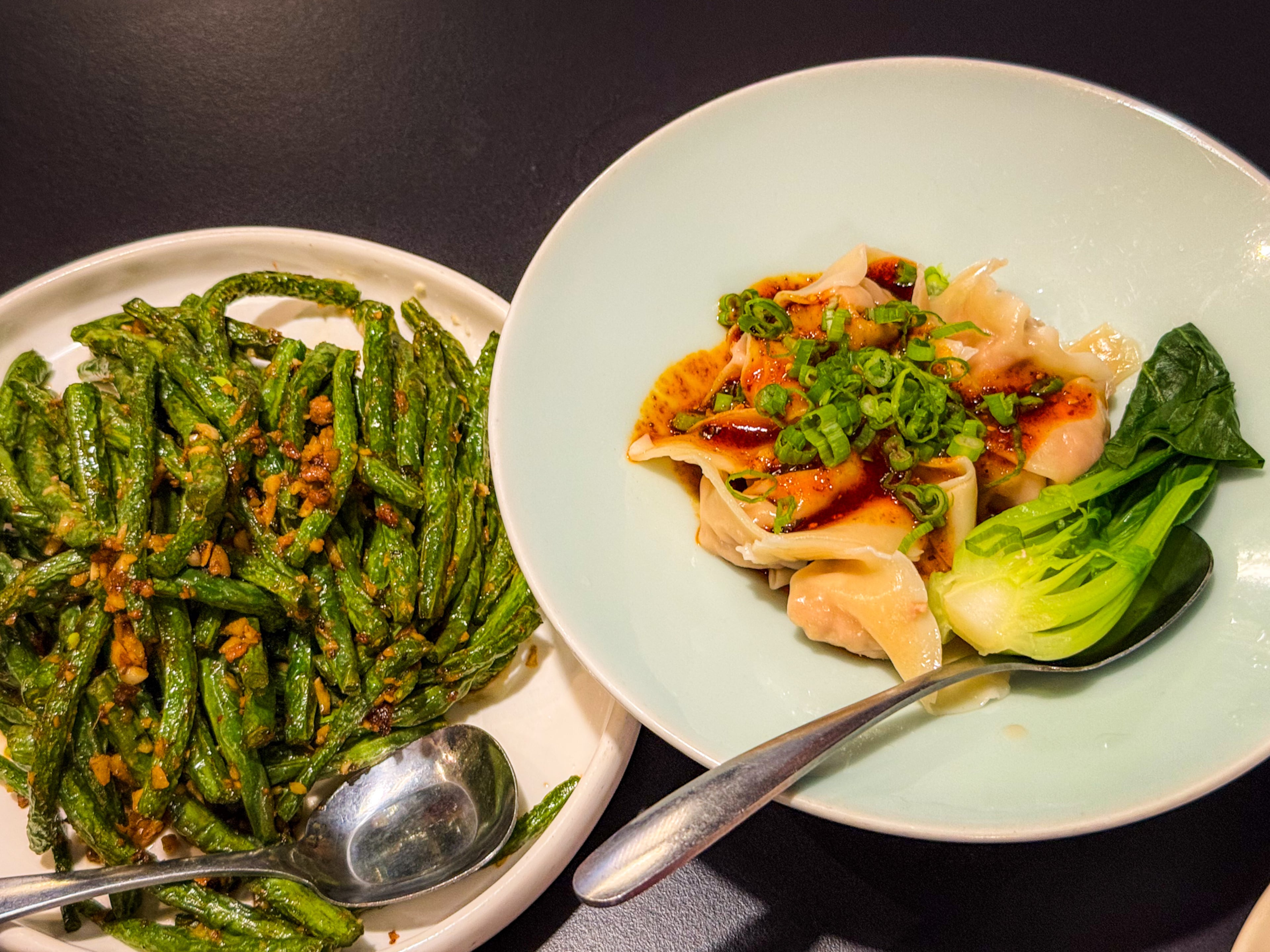 Dry-fried bean sprouts (left) and Sichuan wontons are among the offerings at Chilispot. (Henri Hollis/AJC)