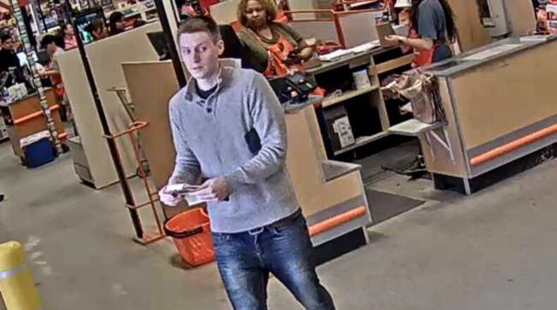 Johns Creek police are searching for a man who they say used a stolen credit card to purchase thousands of dollars worth of gift cards.
