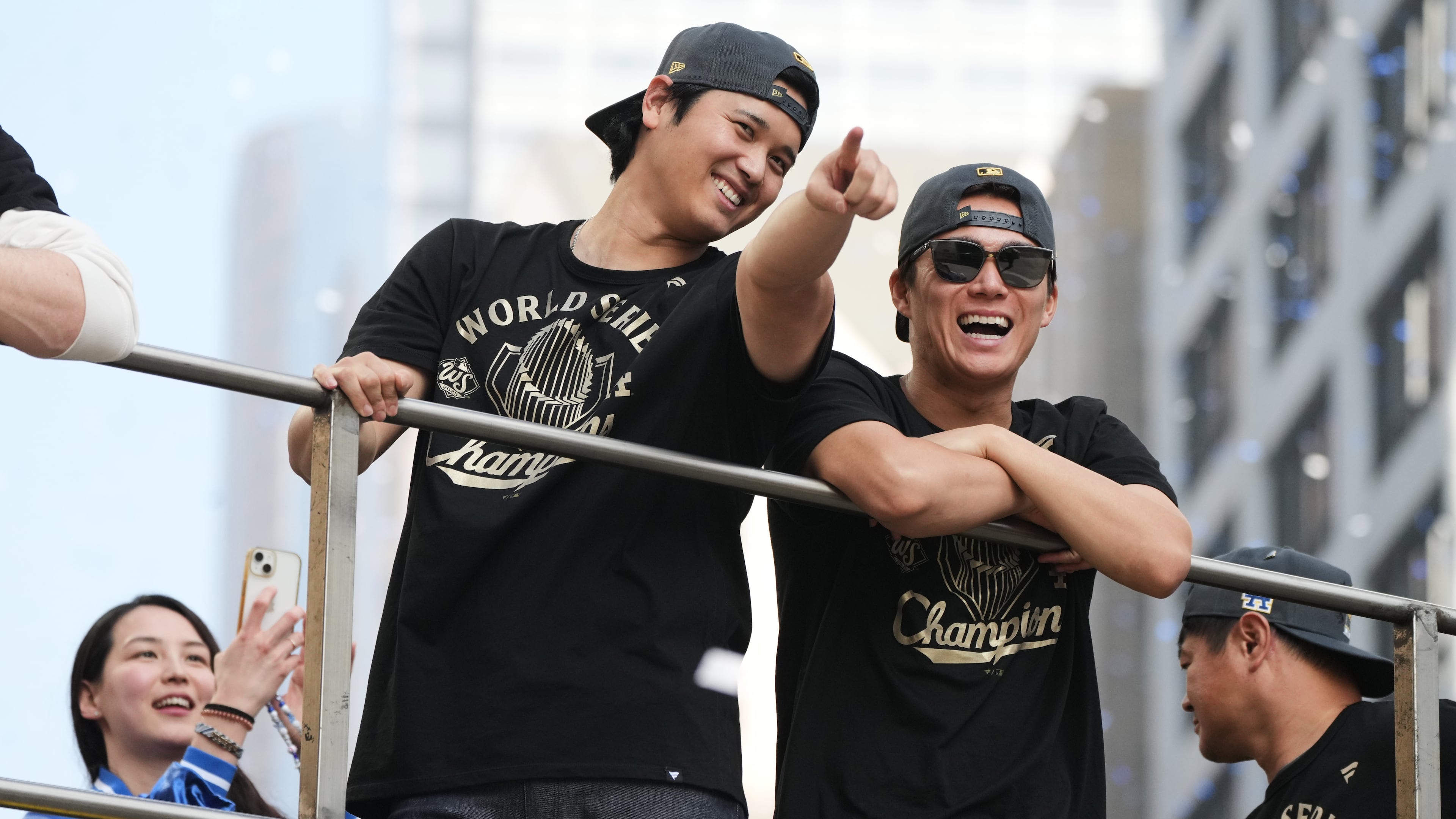 Los Angels Dodgers' Shohei Ohtani, left, and Yoshinobu Yamamoto ride on a double-decker bus during a parade to celebrate the baseball team's World Series win on Monday, Nov. 3, 2025, in Los Angeles. (AP Photo/Jae C. Hong)