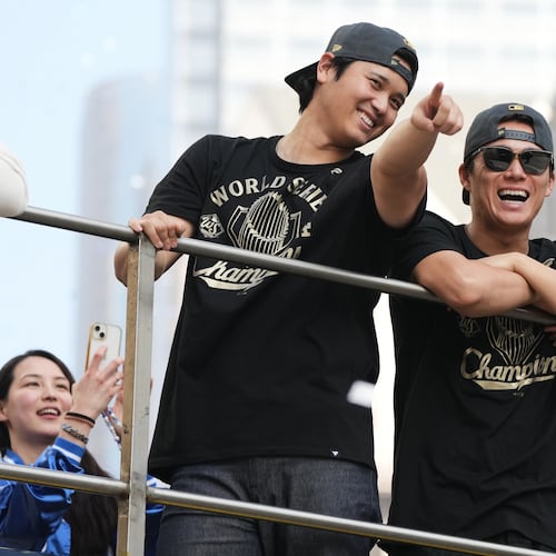 Los Angels Dodgers' Shohei Ohtani, left, and Yoshinobu Yamamoto ride on a double-decker bus during a parade to celebrate the baseball team's World Series win on Monday, Nov. 3, 2025, in Los Angeles. (AP Photo/Jae C. Hong)