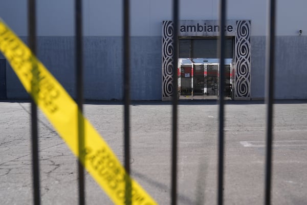 FILE - Caution tape hangs outside Ambiance Apparel after federal immigration authorities conducted an operation on Friday, June 6, 2025, in Los Angeles. (AP Photo/Jae C. Hong, File)