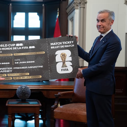 Canada Prime Minister Mark Carney, right, is presented with a novelty World Cup ticket by FIFA President Gianni Infantino on Parliament Hill in Ottawa, Ontario, Friday, Oct. 10, 2025. (Adrian Wyld/The Canadian Press via AP)
