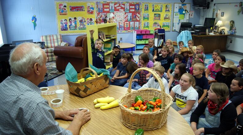 James Farmer of Wide Bottoms Farms in Georgia's White County, talking with children at his community elementary school.