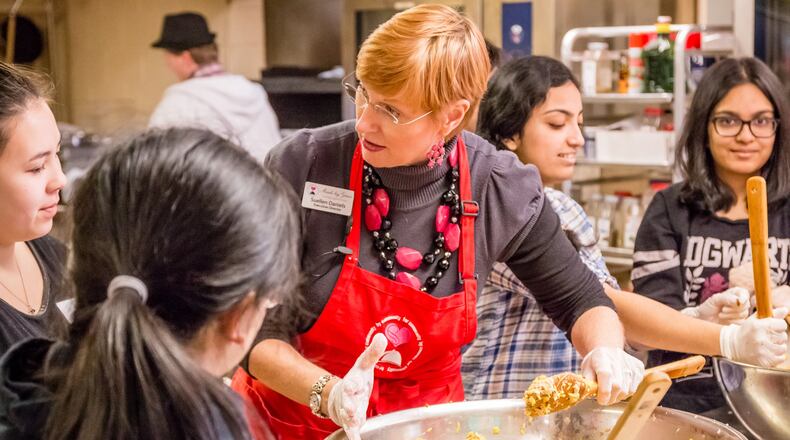 Suellen Daniels makes a batch of cookies with teen volunteers at Meals by Grace, the non-profit she founded in 2011 to help feed hungry school children. Contributed