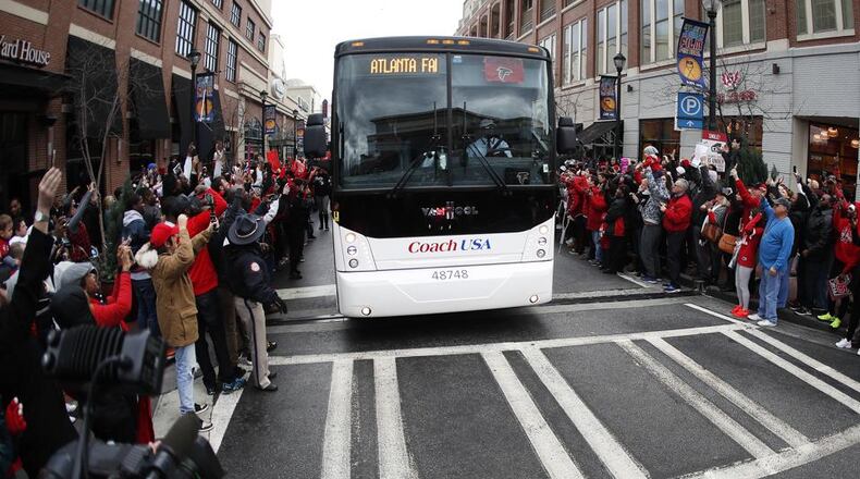 Buses carrying the Atlanta Falcons NFL football team are greeted by cheering fans during a send-off pep rally as they make their way to the airport for a flight to Houston and Super Bowl LI, Sunday, Jan. 29, 2017, in Atlanta. John Bazemore/ AP Photo/John Bazemore