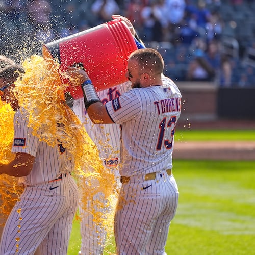 New York Mets' players dump a cooler on Tyrone Taylor, left, after a baseball game against the New York Yankees, Sunday, May 17, 2026, in New York. (AP Photo/Seth Wenig)