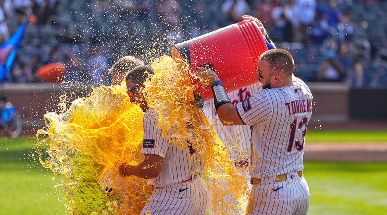New York Mets' players dump a cooler on Tyrone Taylor, left, after a baseball game against the New York Yankees, Sunday, May 17, 2026, in New York. (AP Photo/Seth Wenig)