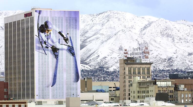 A skier appears to have drifted off the snow covered Wasatch Mountains and down the side of an office tower in Salt Lake City in December 2001 as part of the city's decorations for the 2002 Winter Olympics. (AP Photo/Douglas C. Pizac)