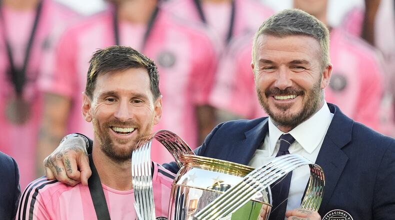 David Beckham poses with the MLS Cup trophy with Inter Miami forward Lionel Messi Saturday, Dec. 6, 2025, in Fort Lauderdale, Fla. (AP Photo/Rebecca Blackwell)