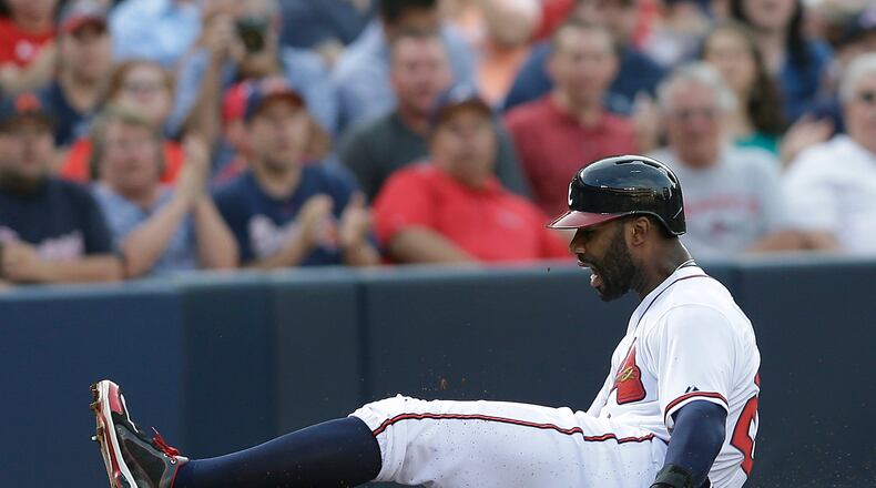Atlanta Braves' Jason Heyward is injured as he slides into third base in the second inning of a baseball game against the Cincinnati Reds, Thursday, July 11, 2013, in Atlanta. Heyward left the game.