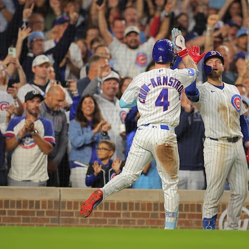 Chicago Cubs' Pete Crow-Armstrong, left, celebrates his home run with teammate Michael Busch, right, during the seventh inning of a baseball game against the Atlanta Braves, Wednesday, Sept. 16, 2026, in Chicago. (AP Photo/Melissa Tamez)