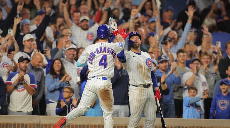 Chicago Cubs' Pete Crow-Armstrong, left, celebrates his home run with teammate Michael Busch, right, during the seventh inning of a baseball game against the Atlanta Braves, Wednesday, Sept. 16, 2026, in Chicago. (AP Photo/Melissa Tamez)