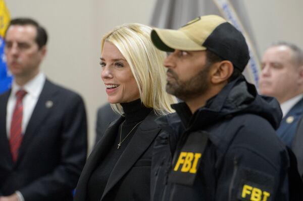 Attorney General Pam Bondi, left, and FBI Director Kash Patel, right, listen as Governor Glenn Youngkin speaks about a 24 year-old MS-13 gang leader who was arrested in an operation by the Virginia Homeland Security Task Force in Dale City, VA., on March 27, 2025, during a news conference at the Manassas FBI Field Office, Thursday, March 27, 2025, in Manassas, VA. (AP Photo/Rod Lamkey)