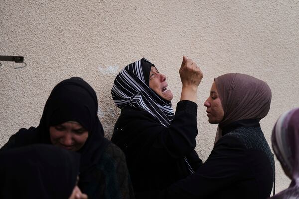 Palestinians mourn their relatives who were killed by an Israeli airstrike, at the hospital in Deir al-Balah, Gaza Strip, on Tuesday, April 8, 2025. (AP Photo/Abdel Kareem Hana)