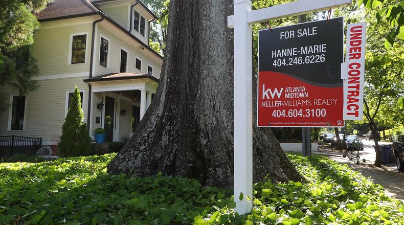 A for sale sign sits in the front yard of an Atlanta house under contract in late May. Curtis Compton/ccompton@ajc.com