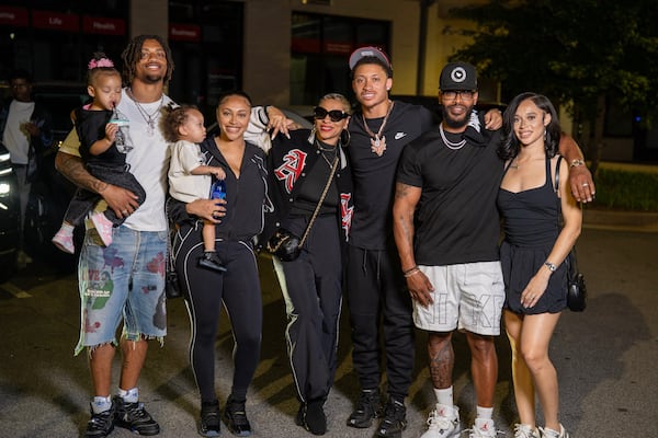Falcons second-round draft pick Avieon Terrell (third from right) poses for a postdraft family photo. New teammate A.J. Terrell is on the far left, holding his daughter. (Courtesy of Aliya Terrell)