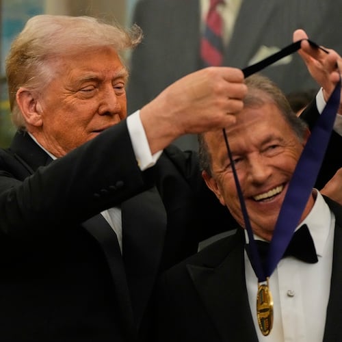 President Donald Trump, left, presents George Strait with his Kennedy Center Honors medal in the Oval Office of the White House, Saturday, Dec. 6, 2025, in Washington. (AP Photo/Julia Demaree Nikhinson)