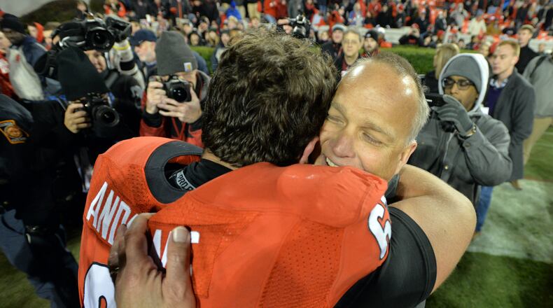 Georgia head coach Mark Richt celebrates the Bulldogs' win over Auburn with center David Andrews in 2014. BRANT SANDERLIN / BSANDERLIN@AJC.COM