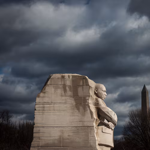 A statue of the Rev. Martin Luther King Jr. looks out over the National Mall in Washington, D.C. Born in Atlanta’s Sweet Auburn community, King emerged in 1955 as a drum major for democracy. (Oliver Contreras for The New York Times 2022)