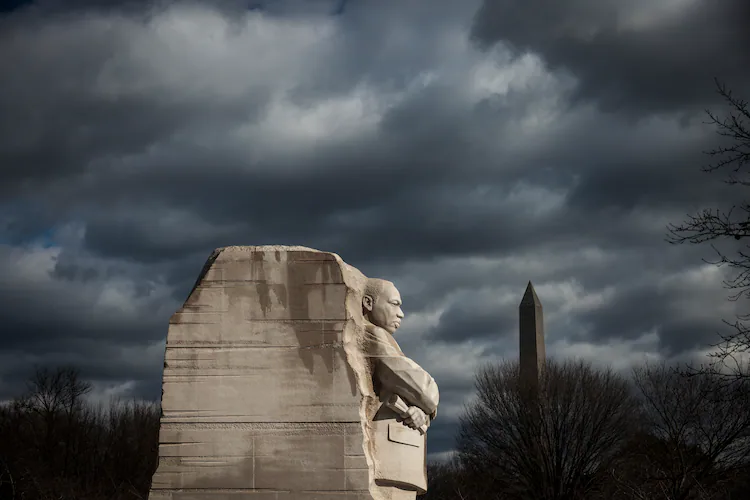 A statue of the Rev. Martin Luther King Jr. looks out over the National Mall in Washington, D.C. Born in Atlanta’s Sweet Auburn community, King emerged in 1955 as a drum major for democracy. (Oliver Contreras for The New York Times 2022)