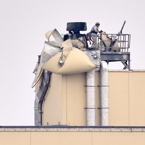 FILE - U.S. embassy personnel inspect the damage caused by a bombing in Baghdad, March 14, 2026. (AP Photo/Hadi Mizban, File)