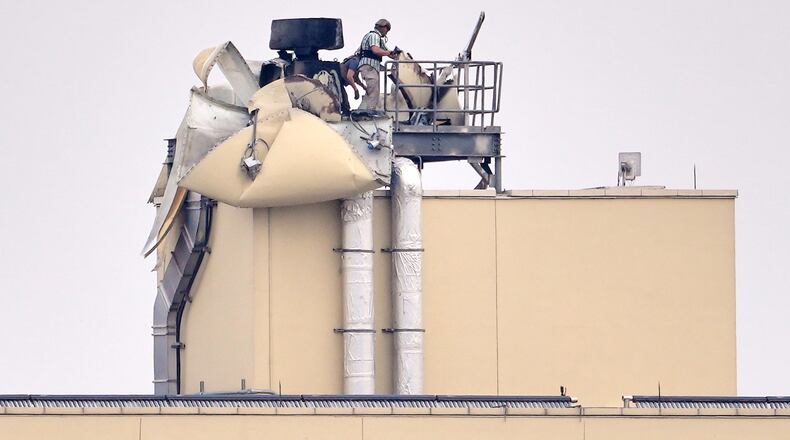 FILE - U.S. embassy personnel inspect the damage caused by a bombing in Baghdad, March 14, 2026. (AP Photo/Hadi Mizban, File)