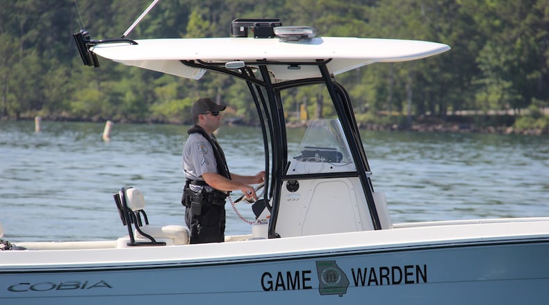 A game warden for the Department of Natural Resources scours Lake Lanier searching for a drowning victim this week.