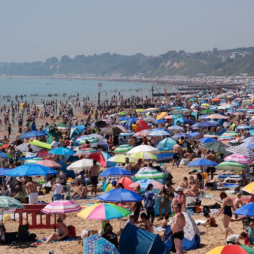 People visit Bournemouth beach, south England, Monday May 25, 2026. (Andrew Matthews/PA via AP)