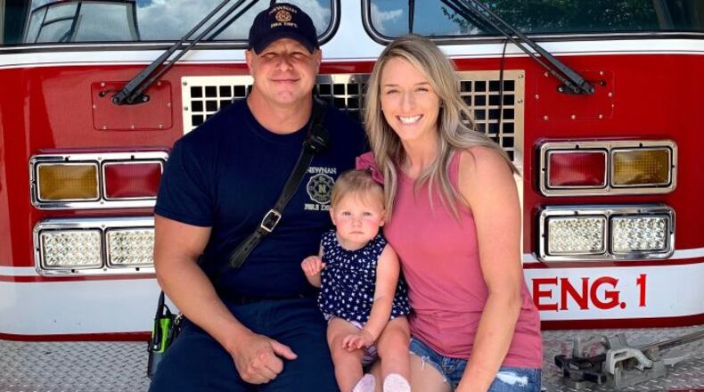 Jason and Becca Scott with their daughter, Harley. The family's house was a complete loss after it was hit by the recent tornado in Newnan. Jason returned to work as a firefighter after ensuring Becca and Harley were safe.