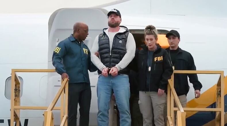 This still photo taken from video and provided by the FBI shows Ryan Wedding a former Canadian Olympic snowboarder facing charges related to drug trafficking and the killing of a federal witness is taken off a plane at Ontario International Airport in Ontario, Calif. on Friday, Jan. 23, 2026. (FBI via AP)